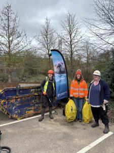 Jo, Lydia and Marting standing by the skip full of rubbish